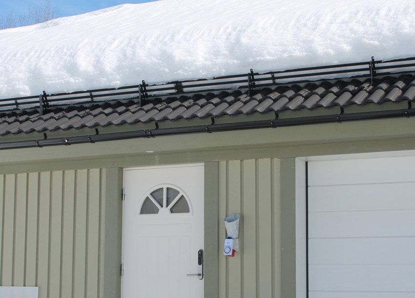 Snöräcke grind håller snön på plats.